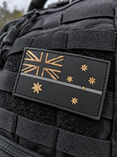 Load image into Gallery viewer, Thin grey line Australian flag PVC patch on black tactical MOLLE webbing — Corrections &amp; Security

