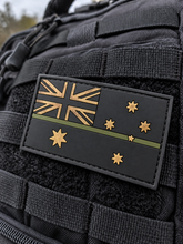 Load image into Gallery viewer, Thin green/olive line Australian flag PVC patch on black tactical MOLLE webbing — ADF
